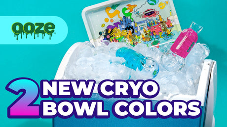 A female hand with light pink nail polish holds the pink and blue Ooze Cryo Glycerin bowls against the Ooze Universe pattern background