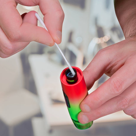 Using an Ooze Resolution Micro Swab to clean the onyx atomizer of a rasta Ooze Booster