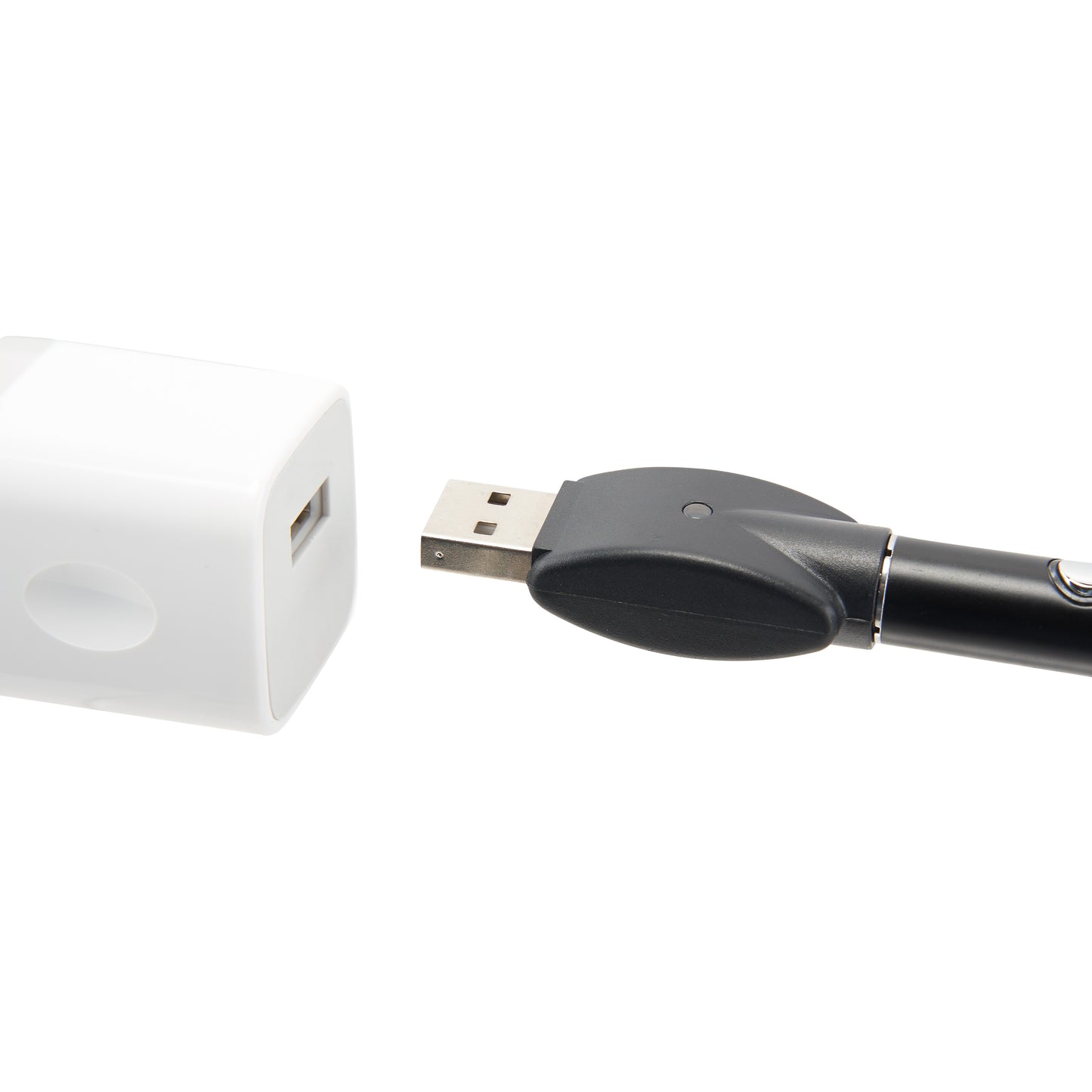 The black Ooze Wink flashlight vape pen is plugged into the 510 charger and is being plugged into a white USB wall adapter