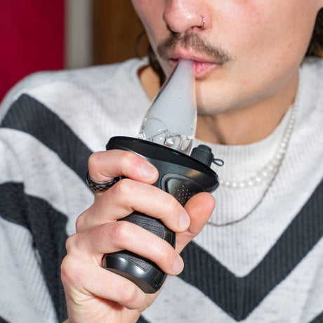 Taking a dab from a black Trigger e-rig