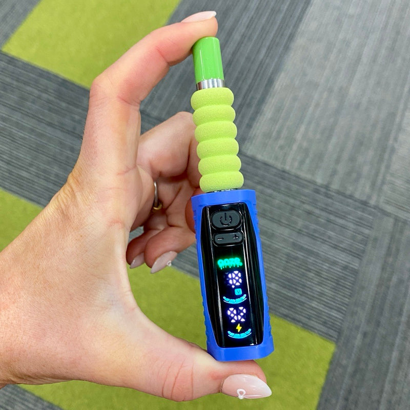 A person pinching blue Ooze Runt Mini Battery with a cartridge attached to show how small it is, with the screen turned on