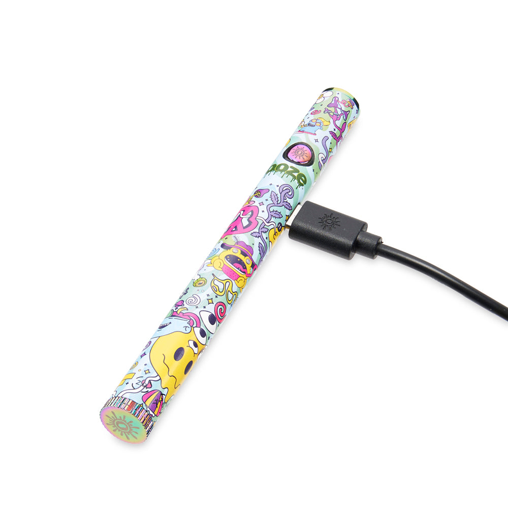 An Ooze Twist Slim Pen 2.0 in Chroma is laying flat with a type C charger plugged into the port on the side.