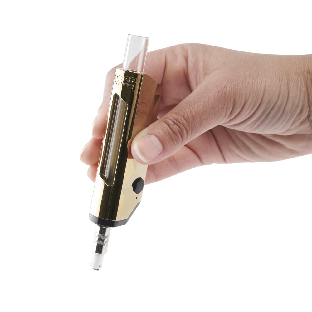 A hand holds the gold Ooze Pronto nectar straw