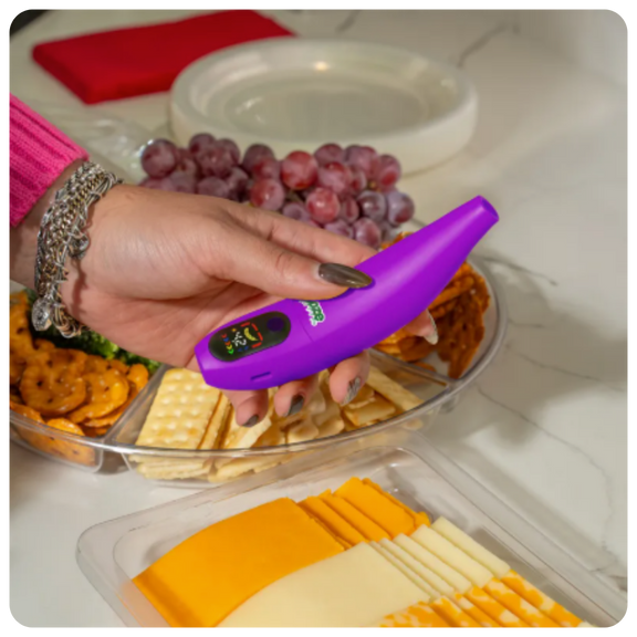 Holding purple Peel over charcuterie