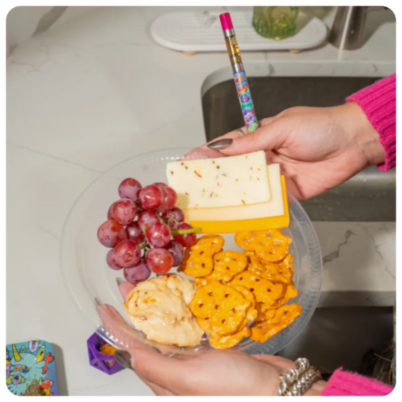 Holding hype engine Twist Slim Pen 2.0 and charcuterie