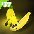 Toy banana with a face and USB port on a dark background, priced at $37.