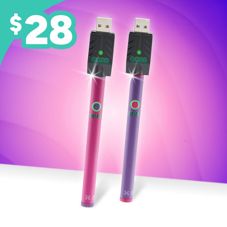 Two USB vape pens, one pink and one purple, standing upright against a purple and pink gradient background with a teal '$28' price badge in the top left corner.