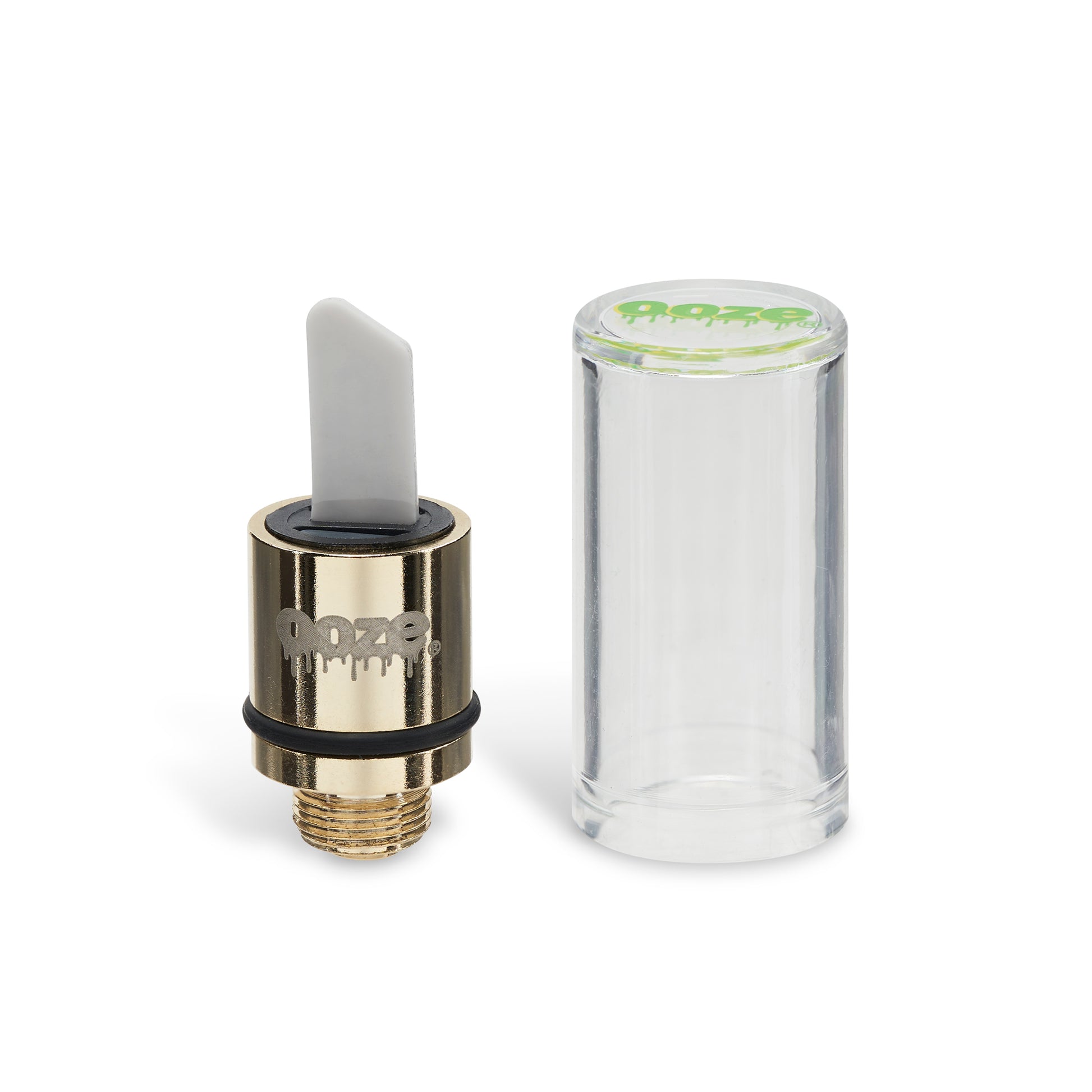 The gold Ooze Hot Knife attachment stands upright next to the clear plastic cap