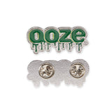 The front of the Ooze enamel pin is at the top and the back of the pin is below. The front shows the green Ooze logo and the back is chrome with 2 metal pin backings.
