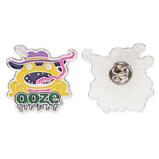 The front and back of the Ooze Trippy Frog enamel pin. The front is colorful and the back is chrome with a metal backing