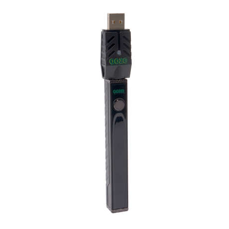 Angled view of the black Ooze Quad 2 square vape with 510 charger attached on a white background
