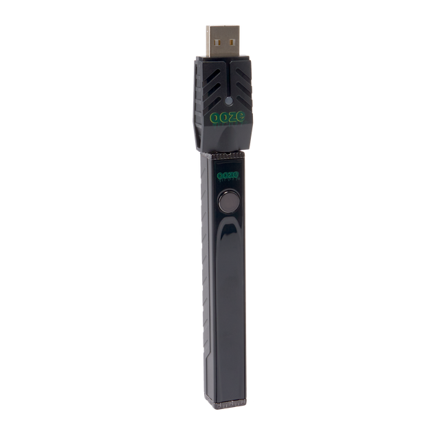 Angled view of the black Ooze Quad 2 square vape with 510 charger attached on a white background