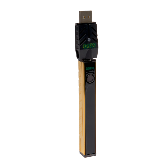 Angled view of the gold Ooze Quad 2 square vape battery with 510 charger attached against a white background
