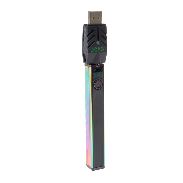 Angled view of the rainbow Ooze Quad 2 battery with the 510 charger attached against a white background