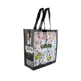 Angled view of the colorful Ooze Hotel Lucky large reusable bag with black sides and handles