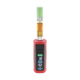 The red Ooze Runt Mini Battery is turned on, standing upright with an oil cartridge connected