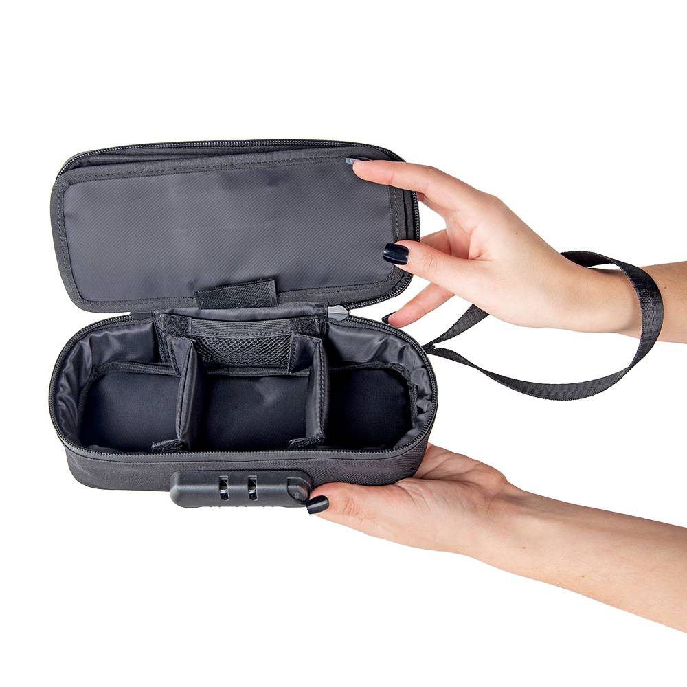 A girl with black nails is holding a black Ooze travel kit open to show the empty storage compartments
