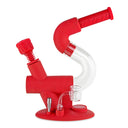 A red Ooze Swerve silicone water pipe with clear glass components, designed in a unique shape resembling the letter 'Z'.