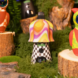 Colorful mushroom figurine with a checkered pattern on a grassy background