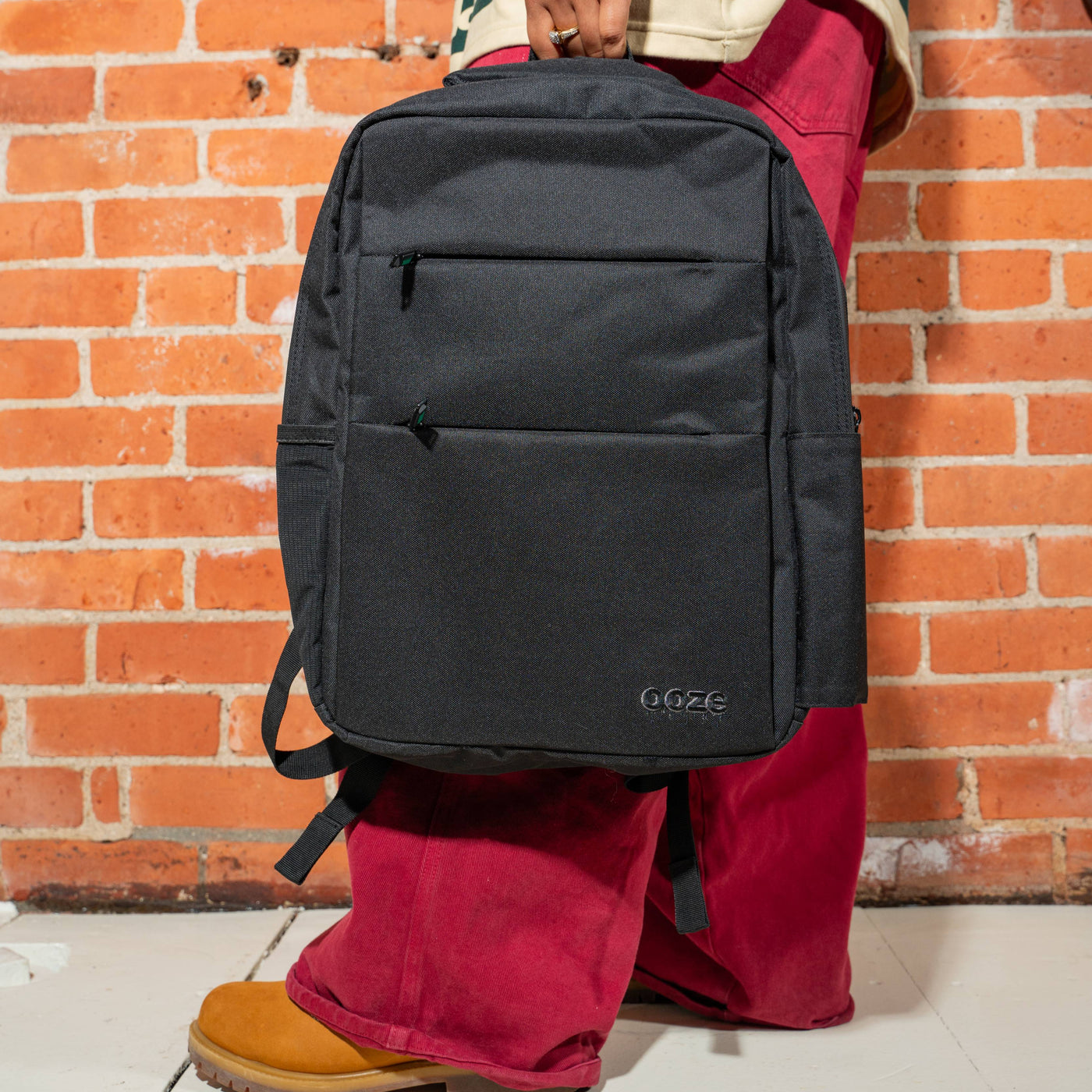 Holding the Gray smell proof Traveler Series backpack 