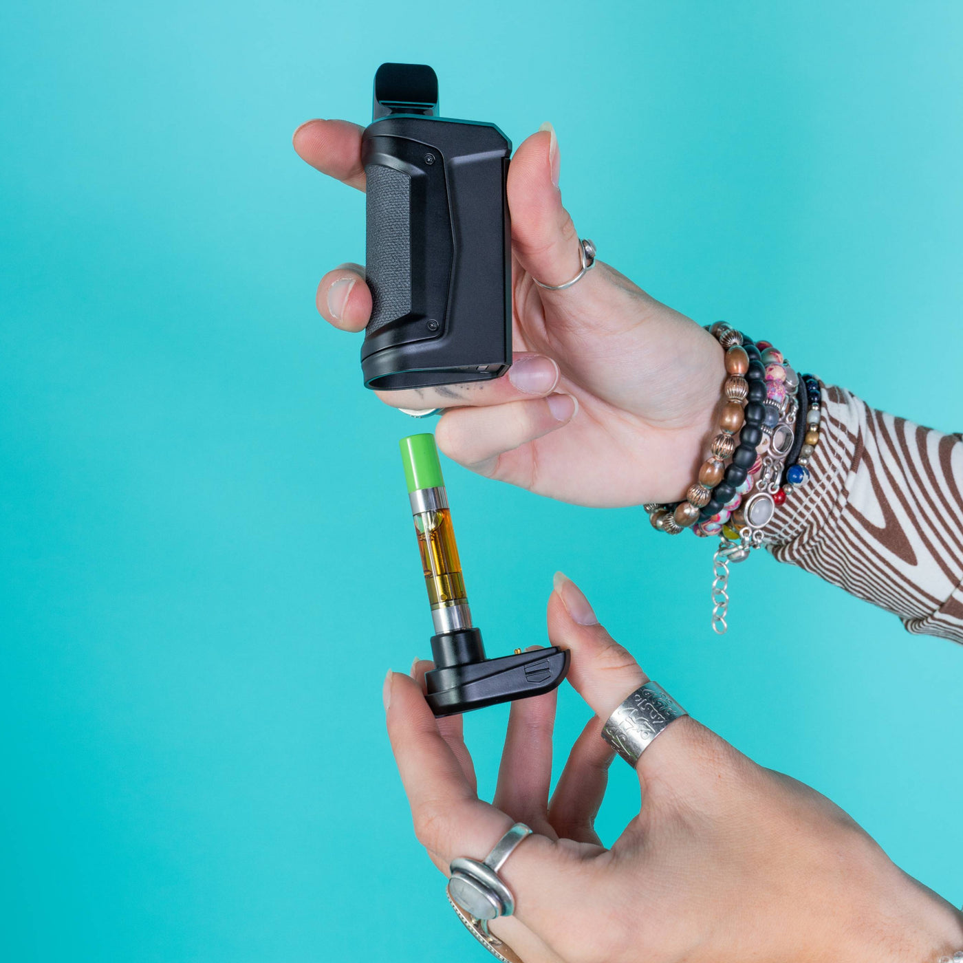 Pulling the base out of a black Duplex 2 vaporizer to show the cart