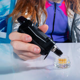 Pointing a black Duplex 2 nectar straw into an open jar of wax