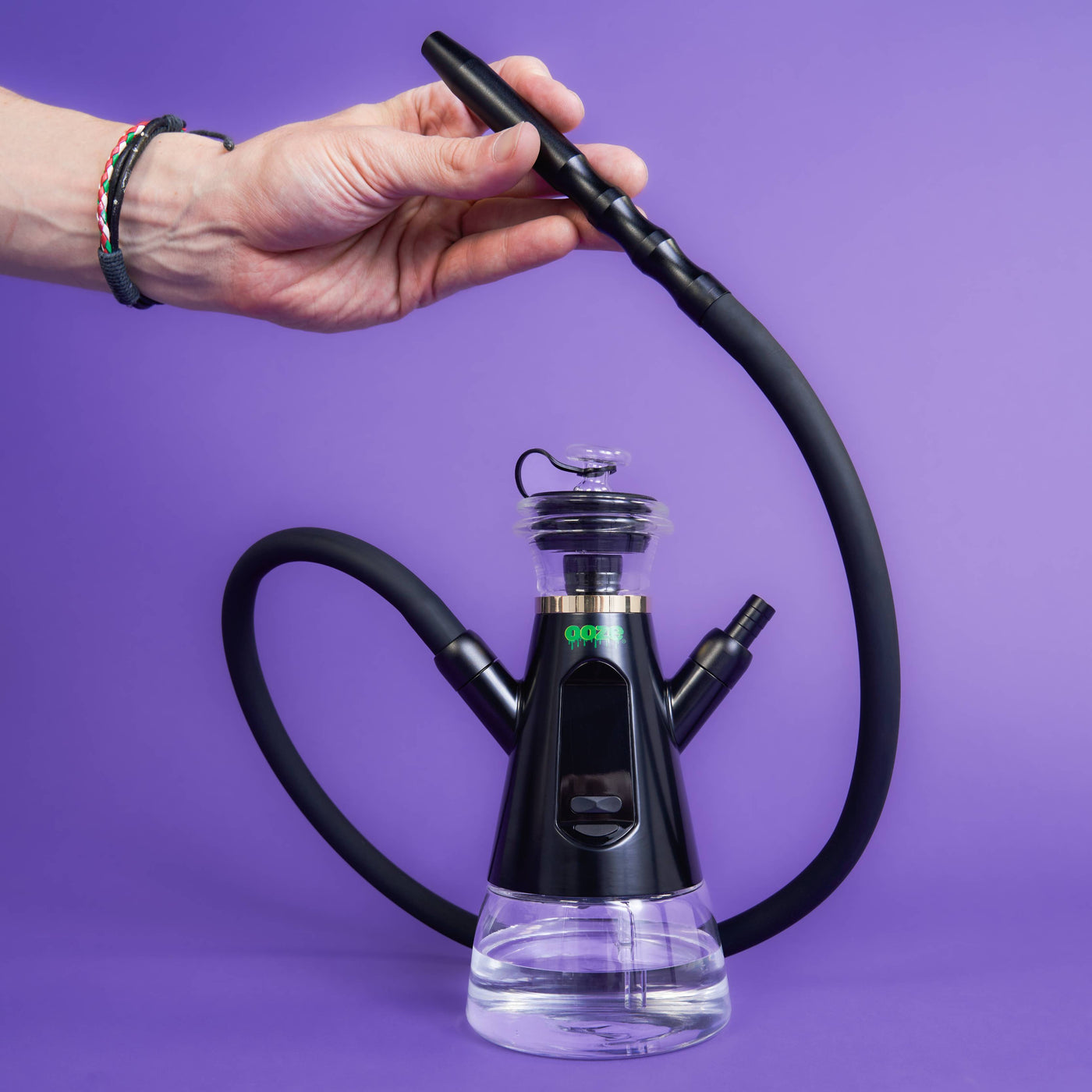 Holding the hose of a black Ripley dab rig hookah