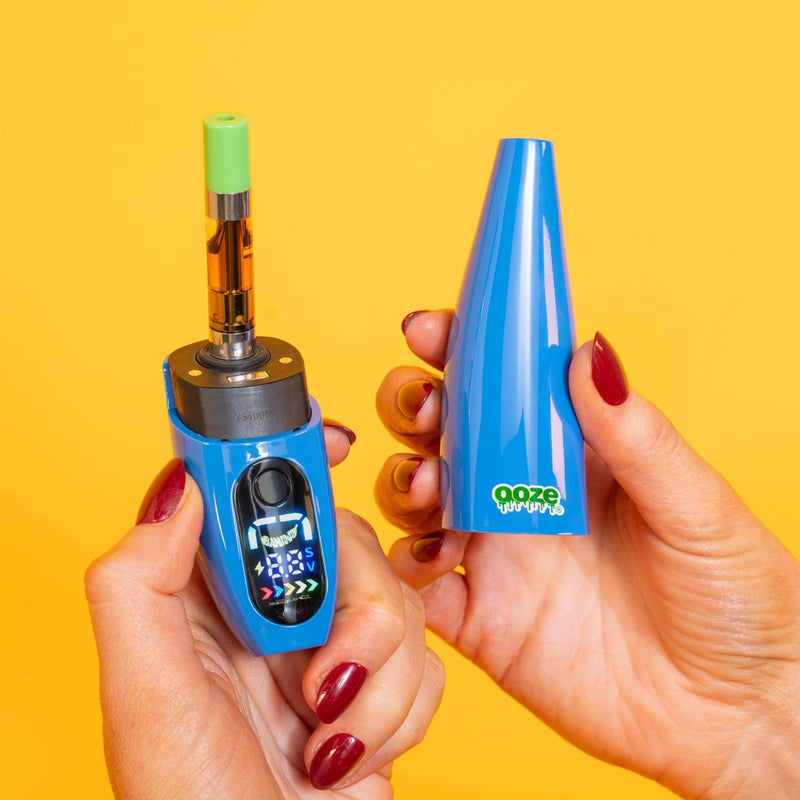 Person holding blue Peel banana battery with two hands: base in one and cap in the other