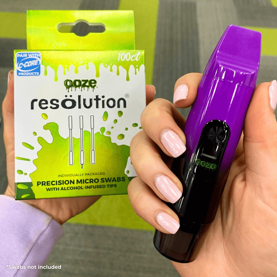One person holding the Purple Booster extract vape and another person holding resolution micro swabs
