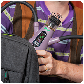 A person taking a lavender Ooze Ripley Hookah Dab Rig from their Ooze Travel Series Smell-Proof Bag