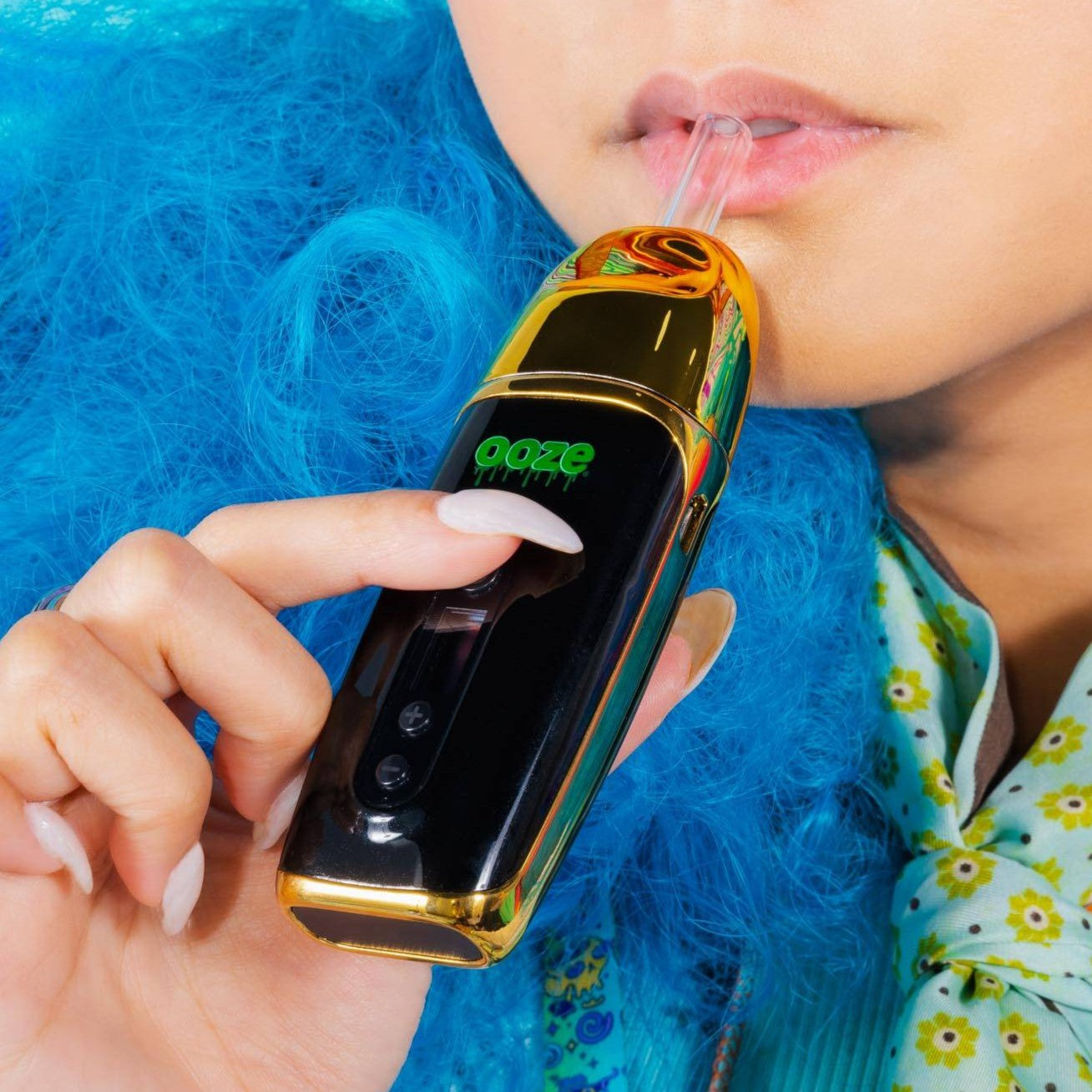 Person using a gold Flare dry herb vape device with 'ooze' branding.