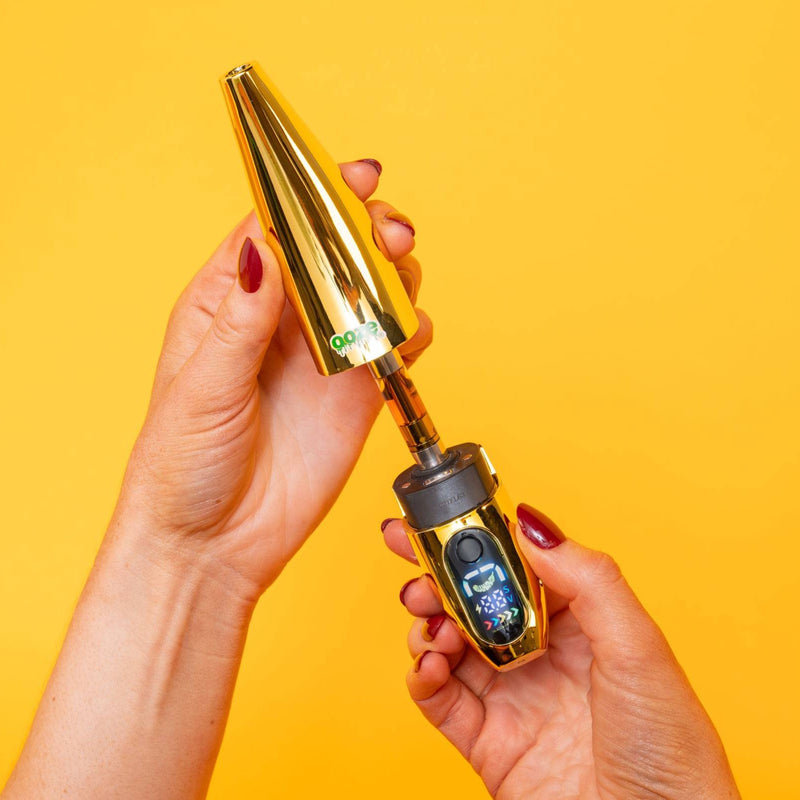 Person removing cap from gold Peel banana battery to show the cartridge inside