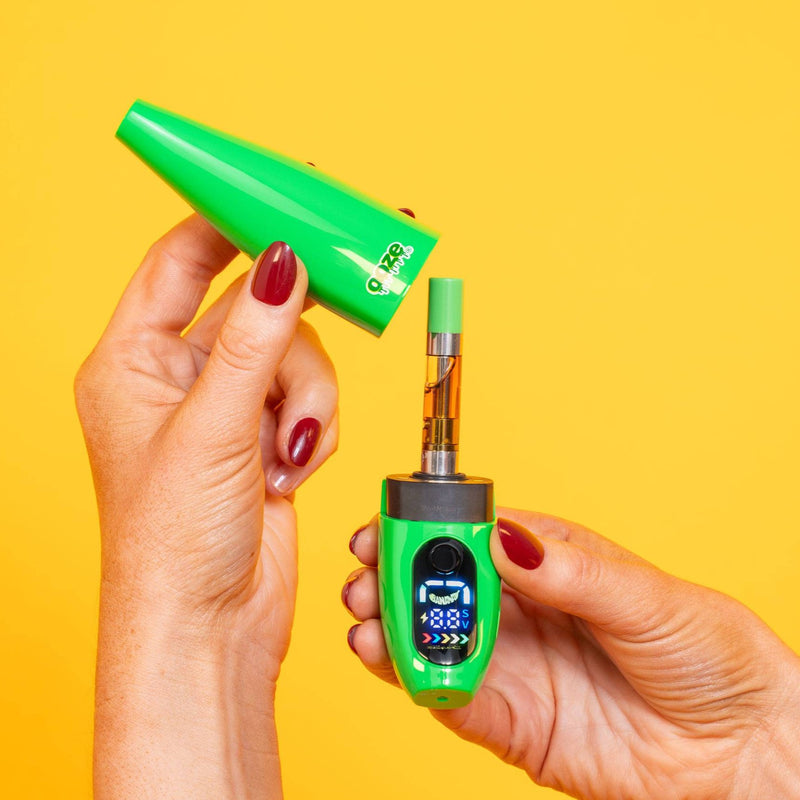 Person taking cap off green Peel banana battery to show 510 cart inside