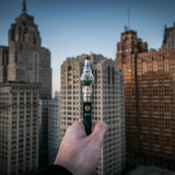 Person holding an Ooze Gusher globe pen on a rooftop in downtown Detroit