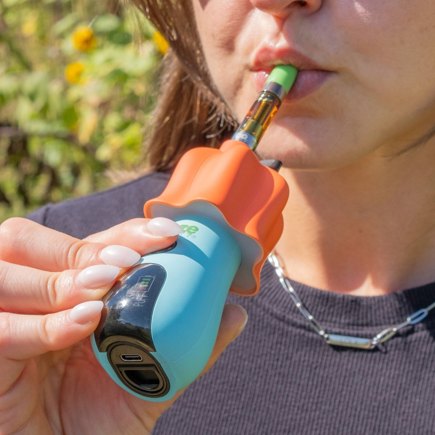 Person taking a hit from Ooze Shroom vape