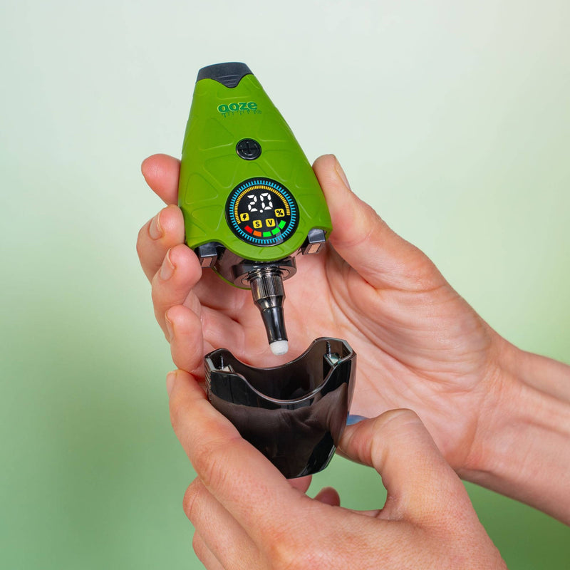 Taking the travel cap off a green Hover device that is turned on