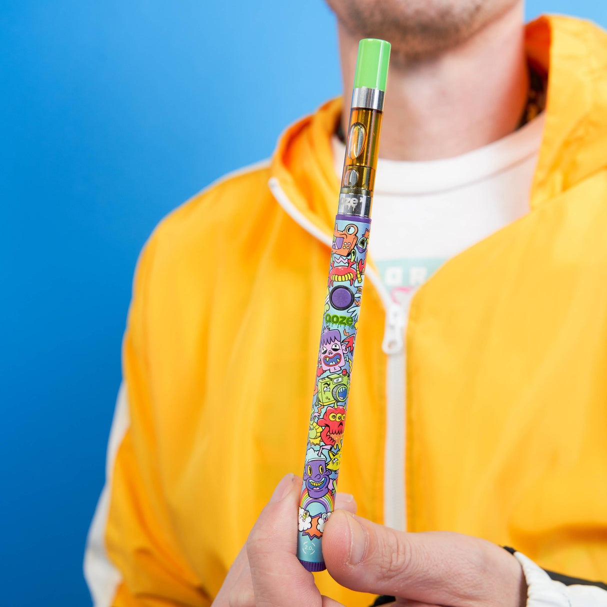 Holding up a Hype Engine Twist Slim Pen 2.0 with a green-tipped cart attached