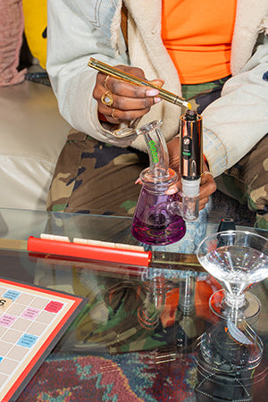 Person loading an Ooze Booster with an Ooze Hot Knife connected to an Ooze Glyco.