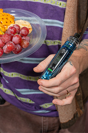 A person holding an Ooze Titan in their hand at a party.