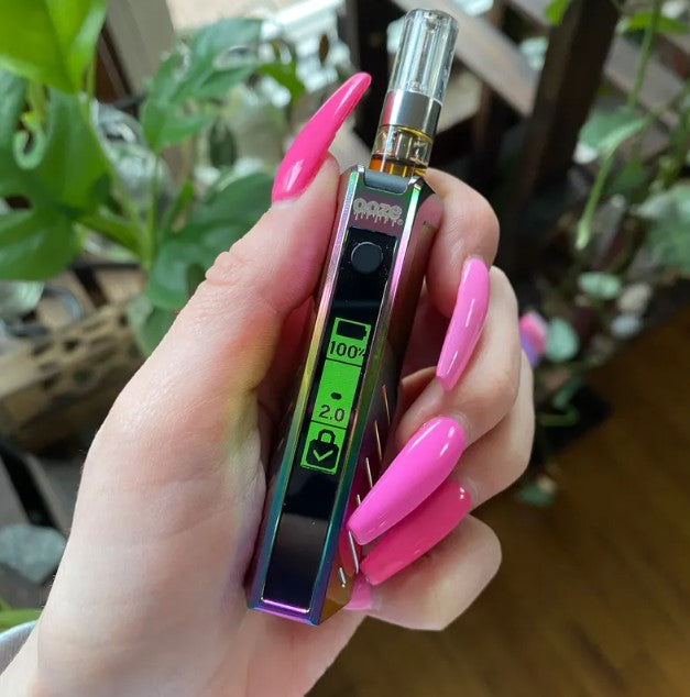 Hand with pink nails holding Novex 2 Rainbow THC Pen