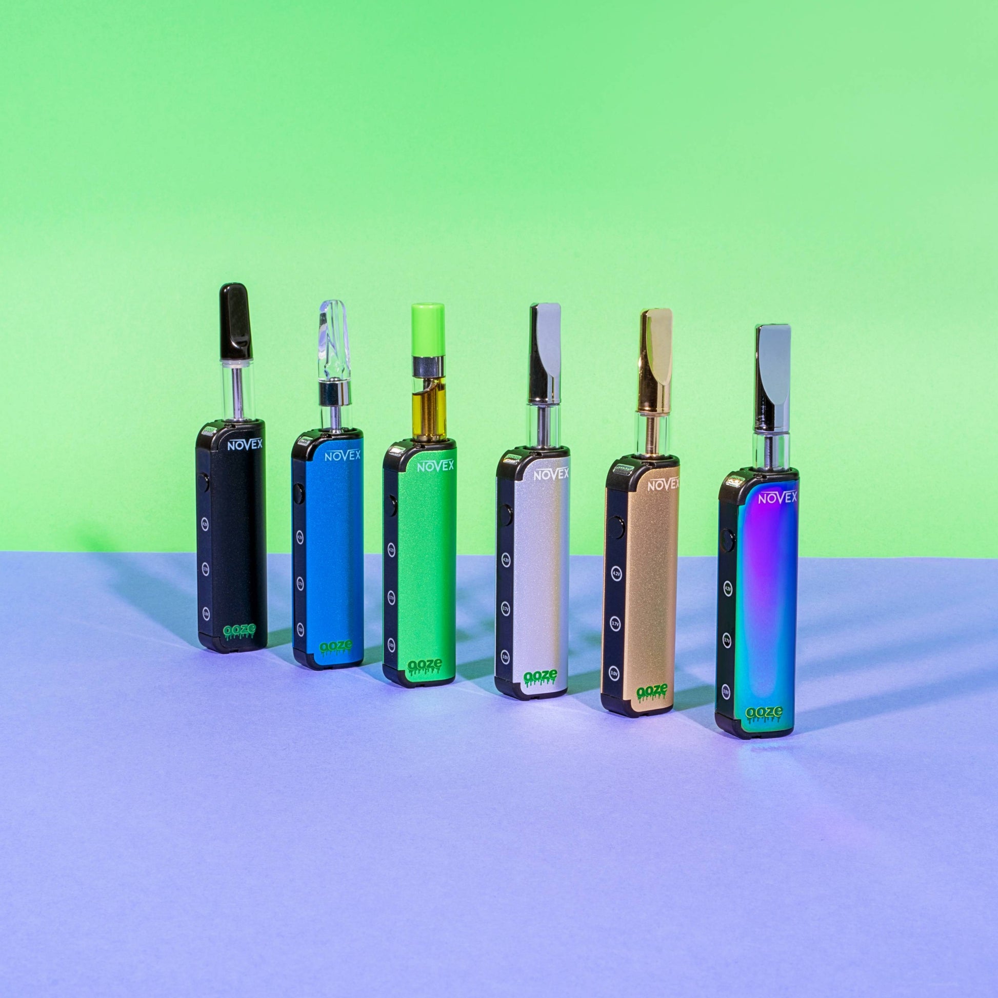 All 6 colors of the Ooze Novex battery are lined up, each has a 510 cartridge inserted