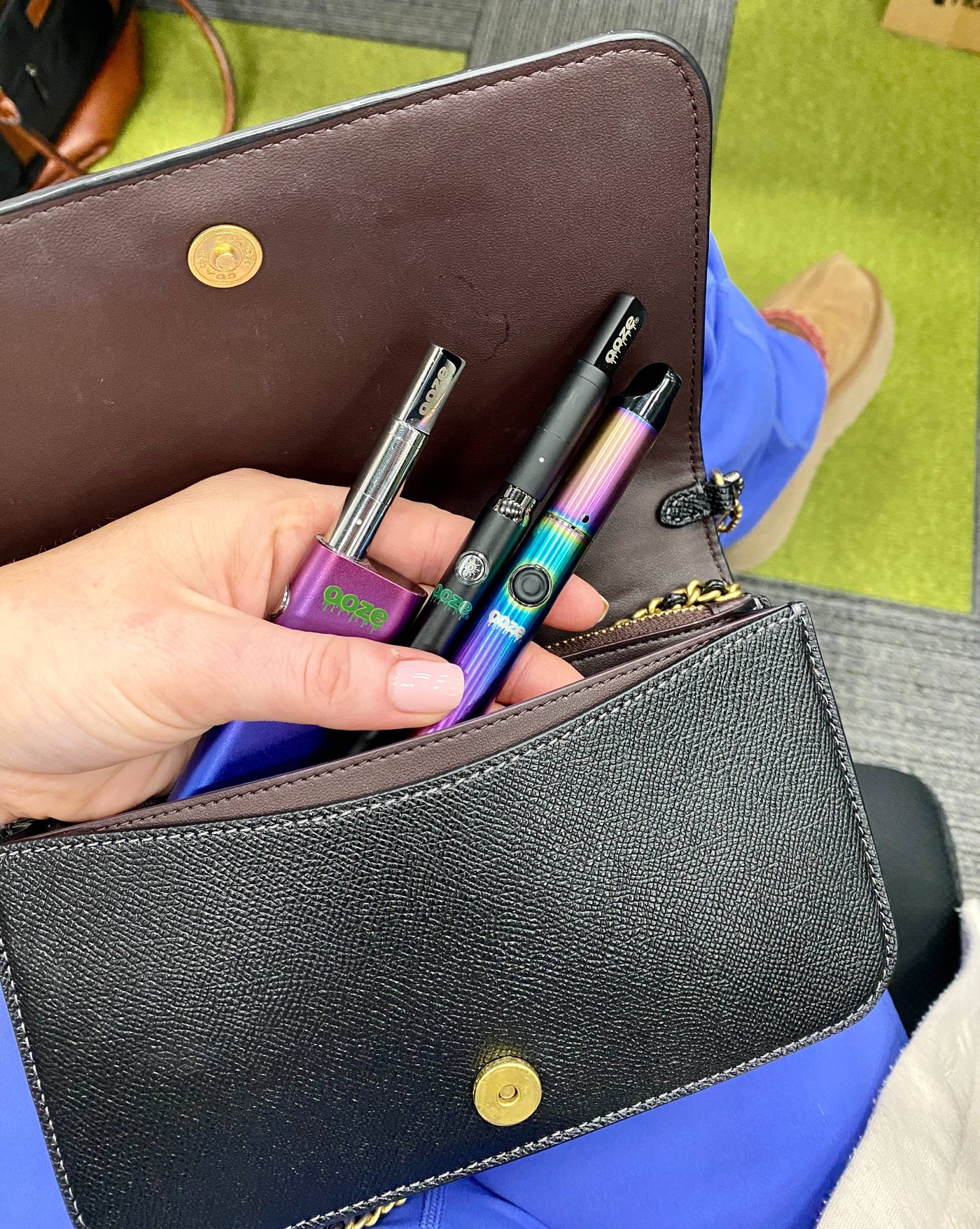 Pulling a rainbow Ooze Vault and other batteries out of a black purse