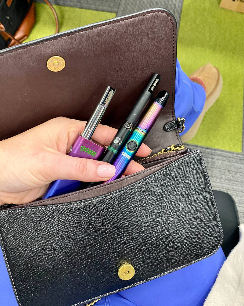 Pulling a rainbow Ooze Vault and other batteries out of a black purse