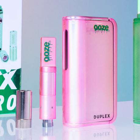 Pink Ooze Duplex vape pen with the matching pink wax atomizer and magnetic 510 ring on a reflective surface.