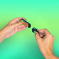 A girl with green nails is attaching the magnetic charger to the bottom of an Ooze Novex