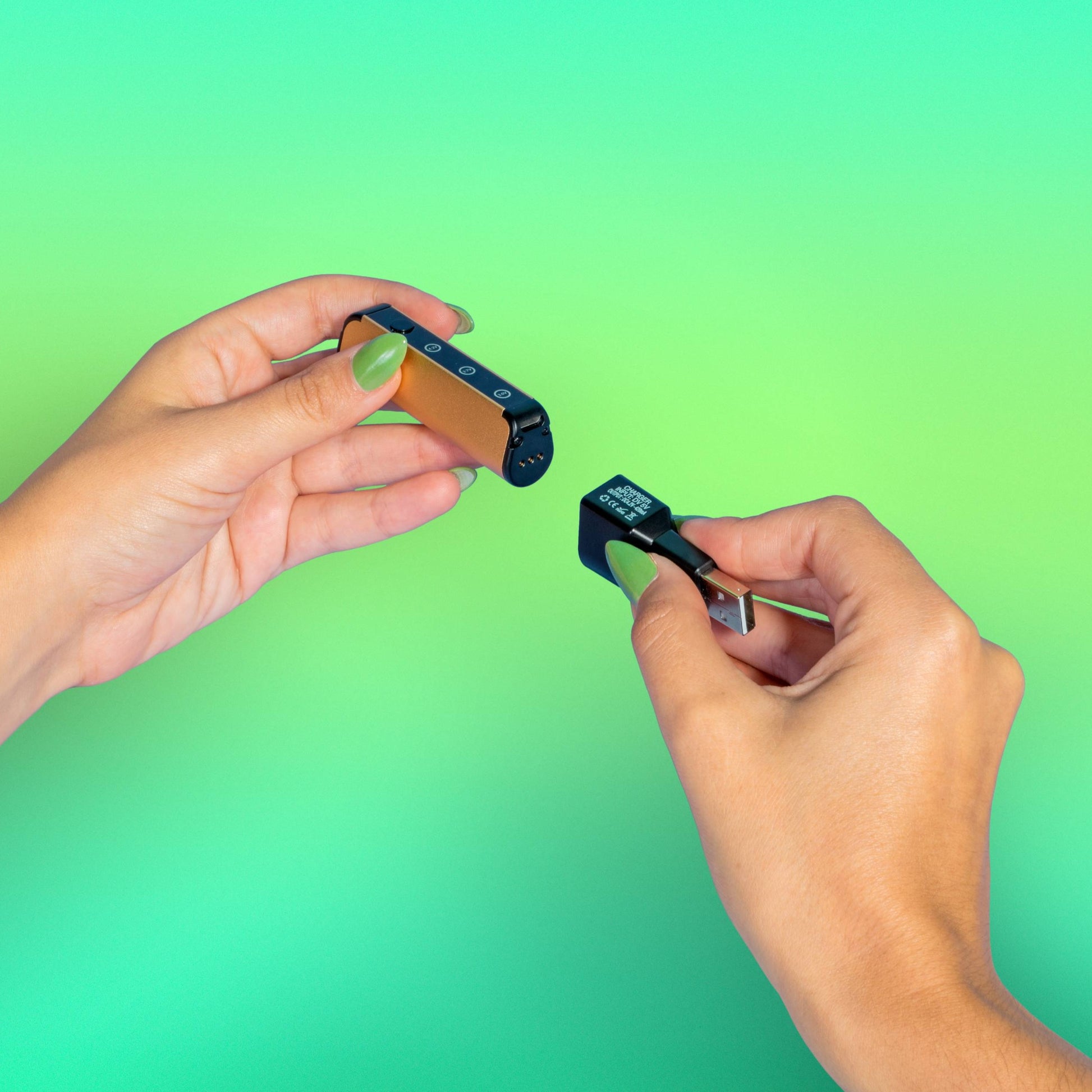 A girl with green nails attaches the magnetic charger to an Ooze Novex