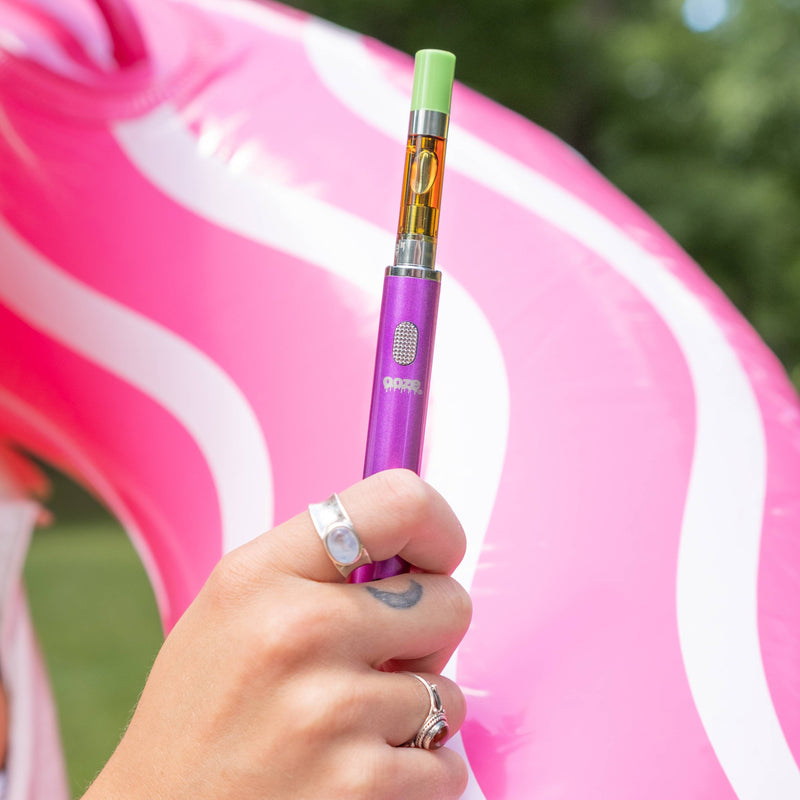 Holding a purple Smart Battery up in front of a pink inner tube