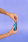 A girl with green nails screws a 510 cartridge into an Ooze Novex