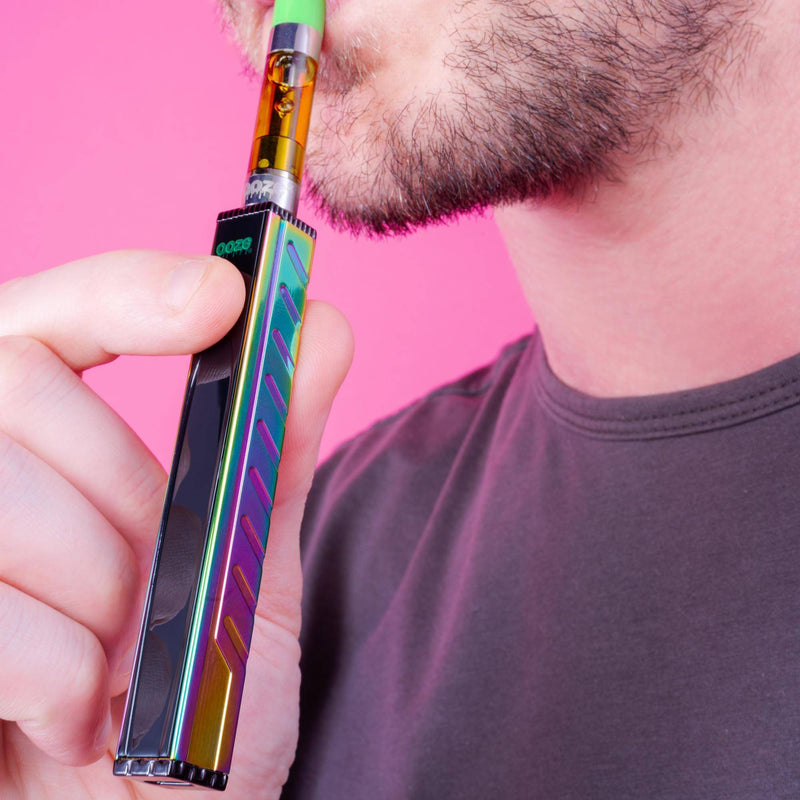 Taking a hit from a rainbow Quad 2 vape battery