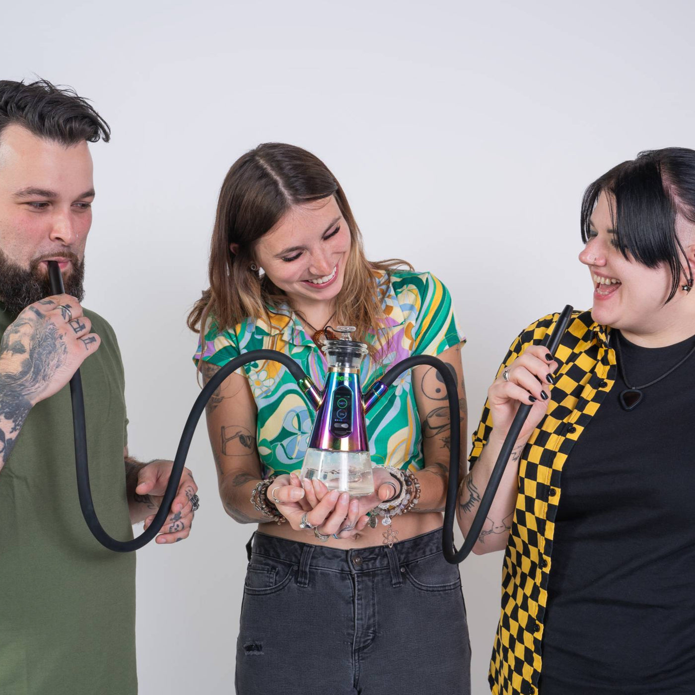 Three friends using a rainbow Ripley dab rig hookah